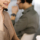 Young friendly girl in headsets is talking to a firm's client, while sitting at the desk in a modern office together with her colleague. Call center operators at work.